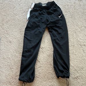 Nike basketball pants with drawstring at the bottom of pant legs. Black